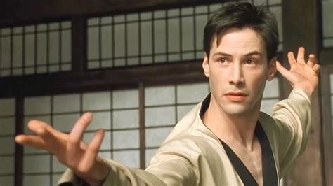A screenshot from the first Matrix movie. Keanu Reeves, playing "Neo," does a "bring it on" pose during the scene where he instantly knows Kung-Fu.
