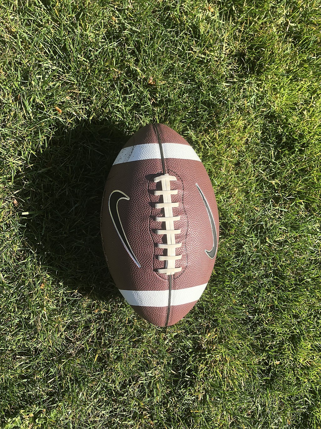 A photo of a football on the ground.